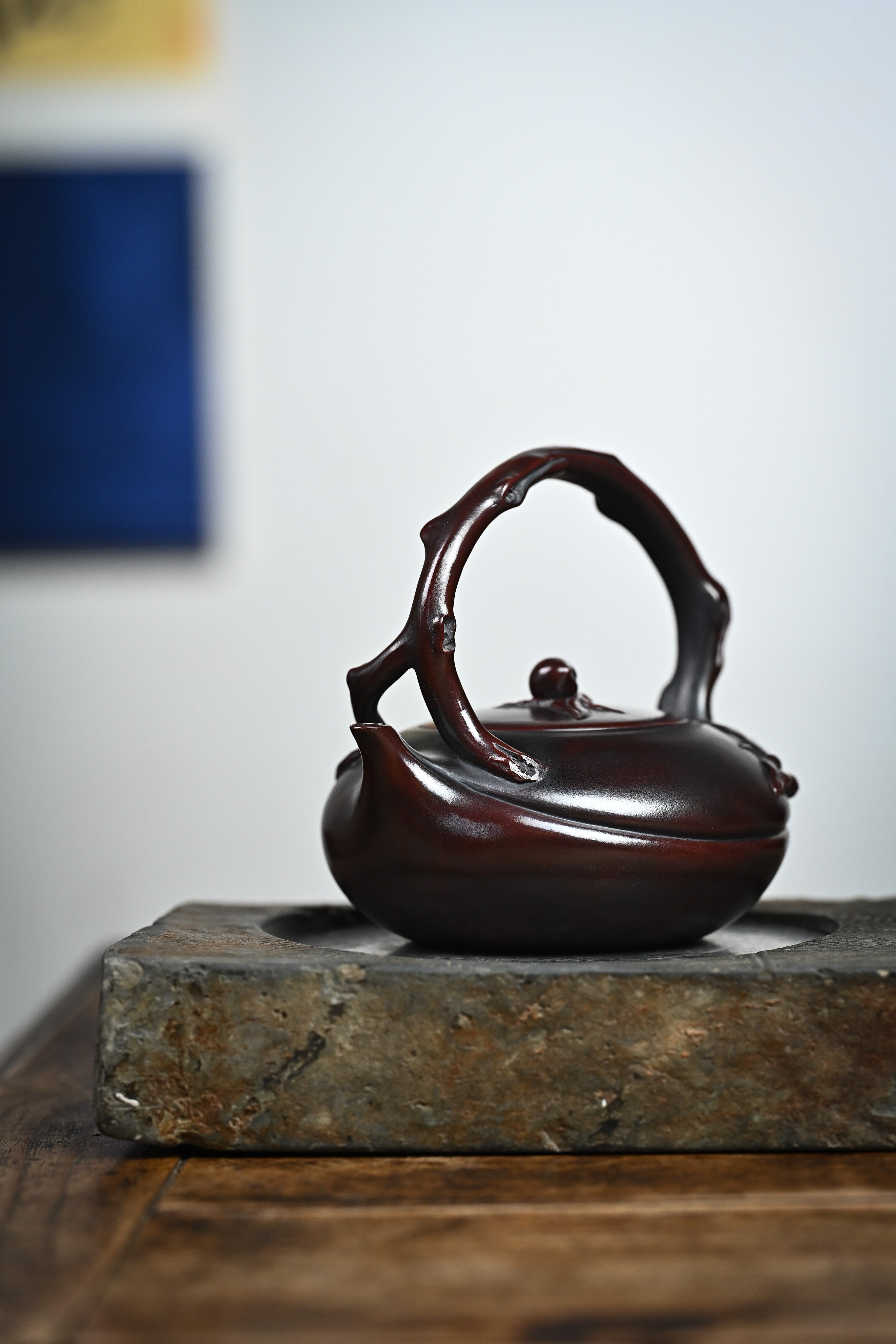 Handmade YANYOO Yixing teapot featuring aged Wuni clay and peach design, Shou Tao, lifestyle front side.