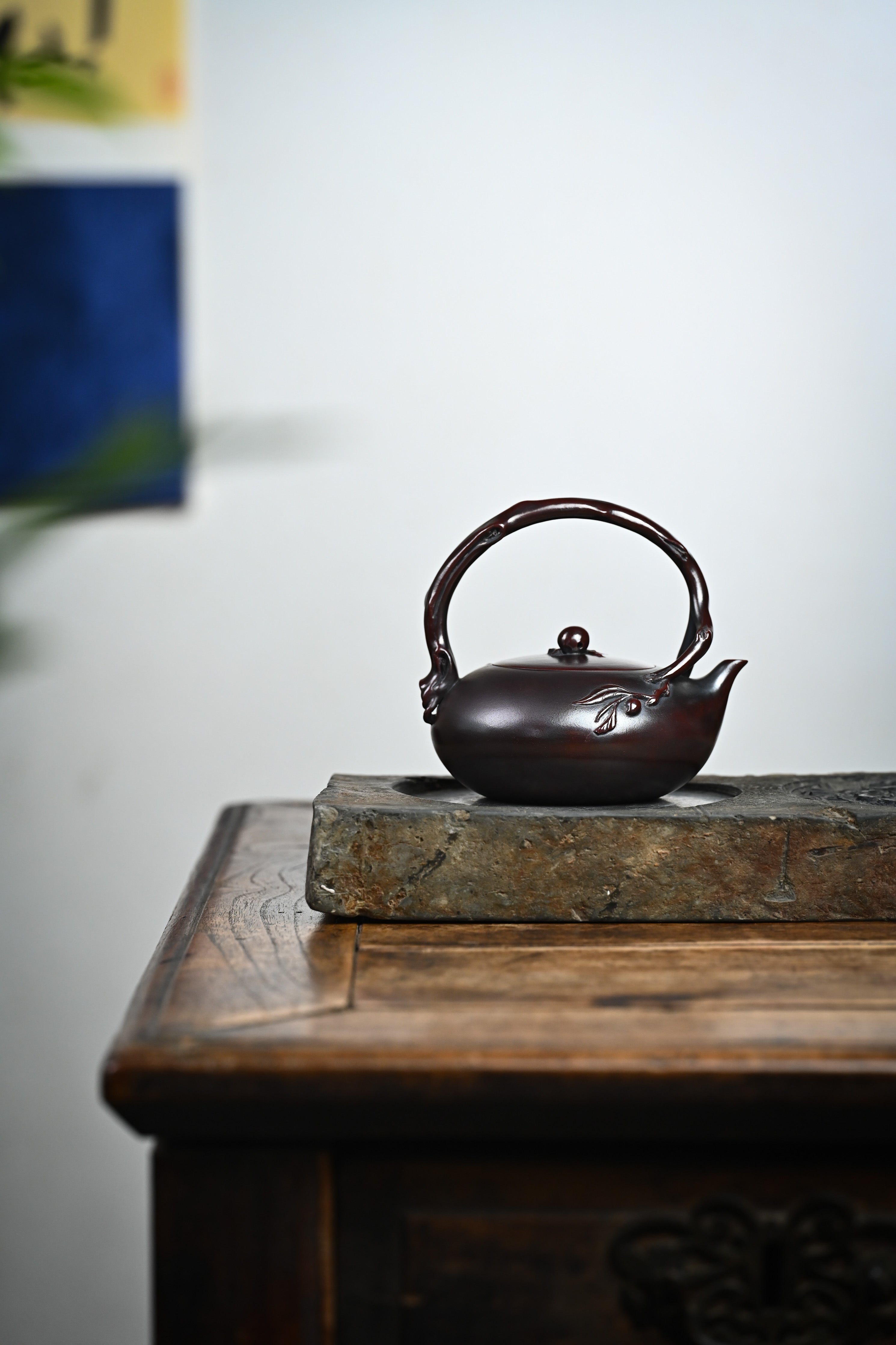 Handmade YANYOO Yixing teapot featuring aged Wuni clay and peach design, Shou Tao, lifestyle wide-angle right side.