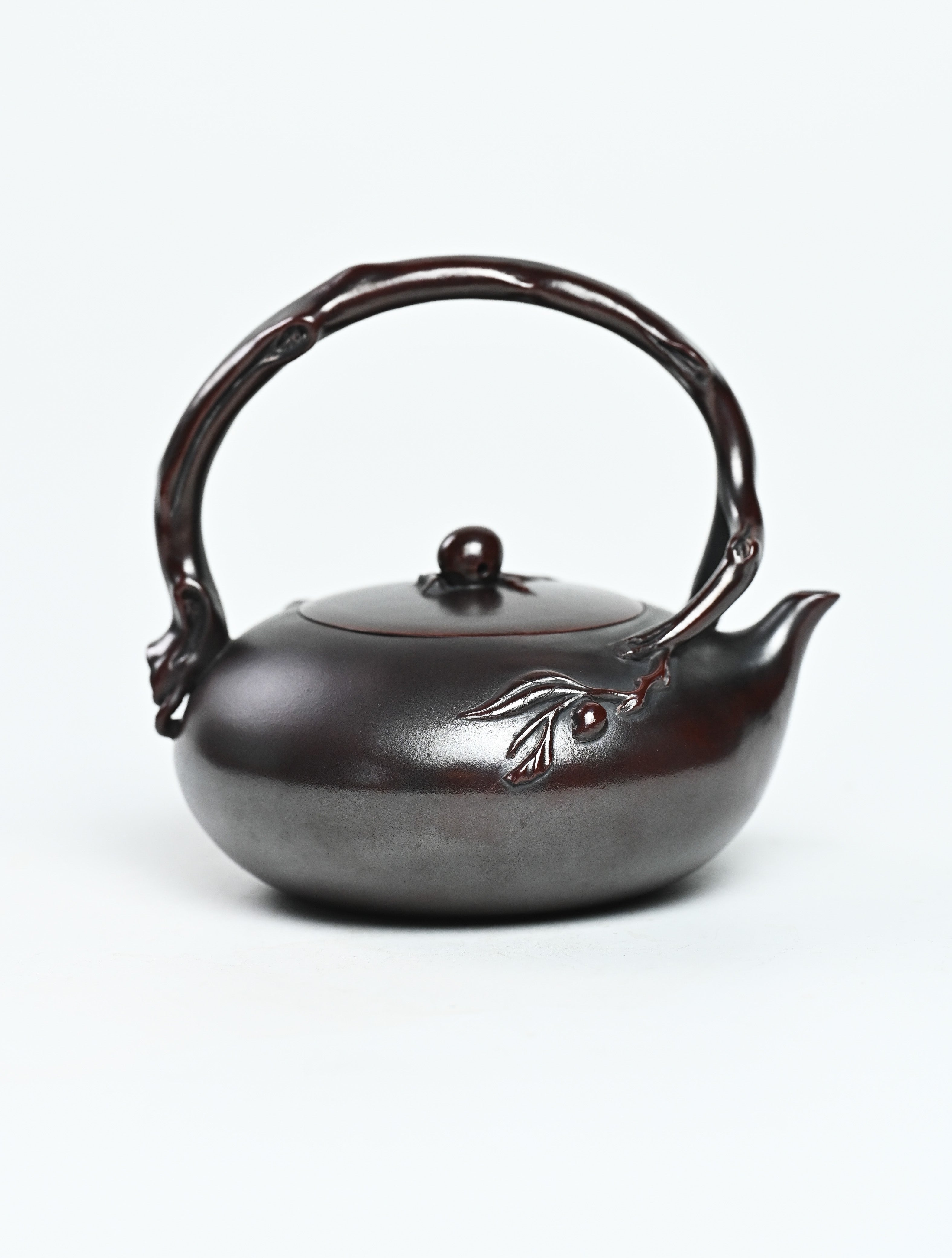 YANYOO handmade Yixing teapot featuring aged Wuni clay, lifting handle and peach sculpture, product right side.
