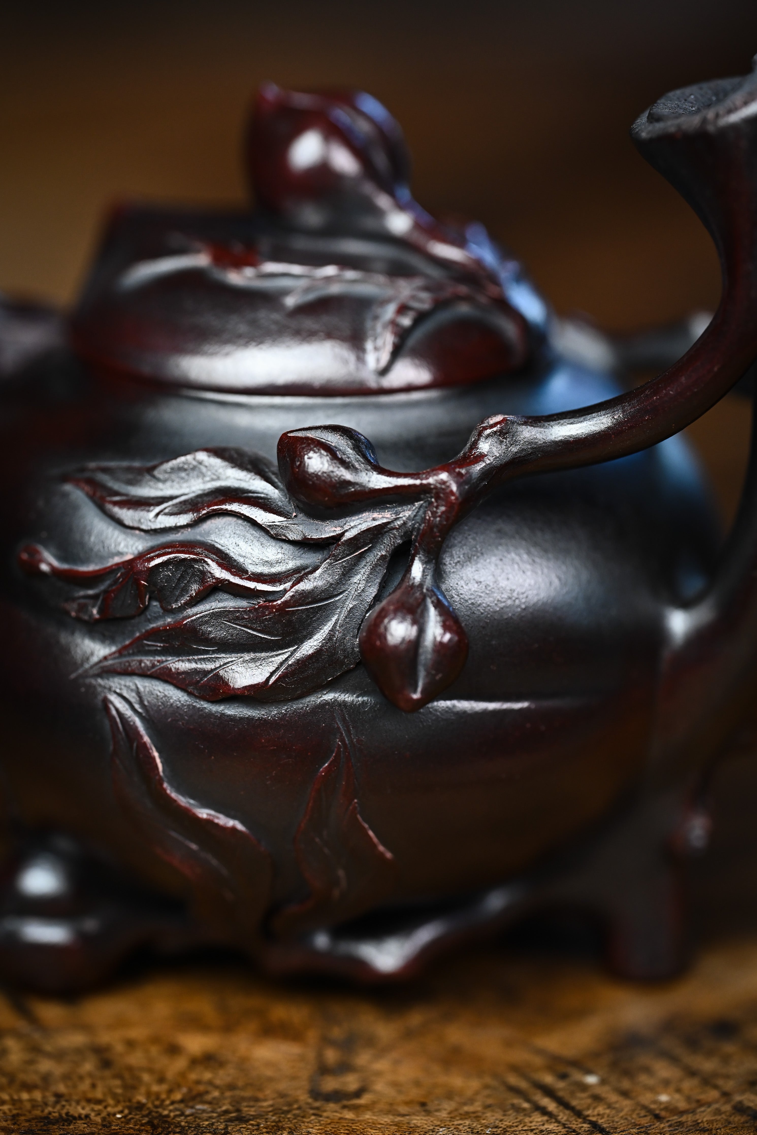 Handmade YANYOO Yixing teapot featuring aged Wuni clay and peach design, lifestyle detail front side.