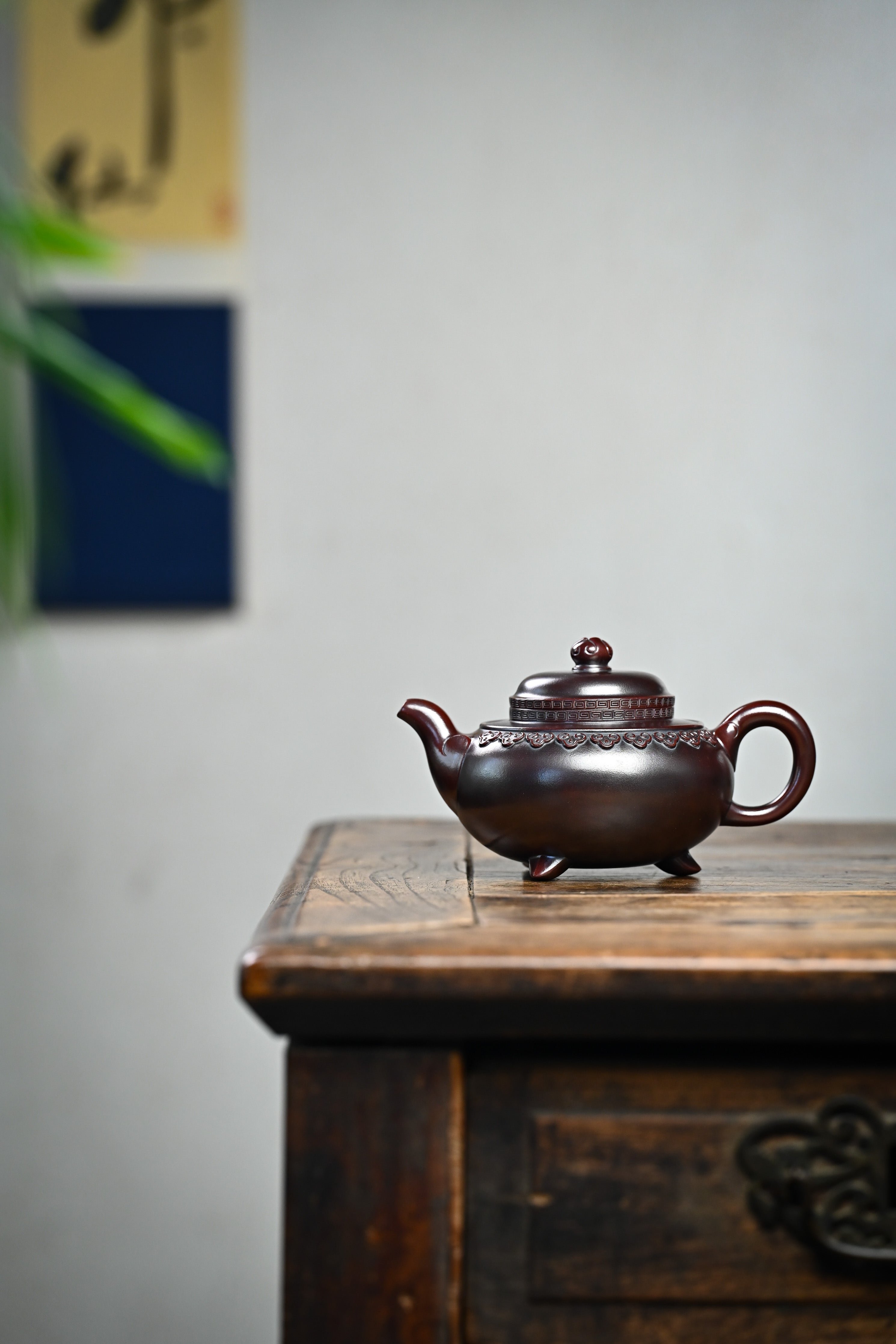 Handmade YANYOO Yixing teapot featuring aged Wuni clay and Ru Yi pattern, Fang Gu, lifestyle wide-angle left side.