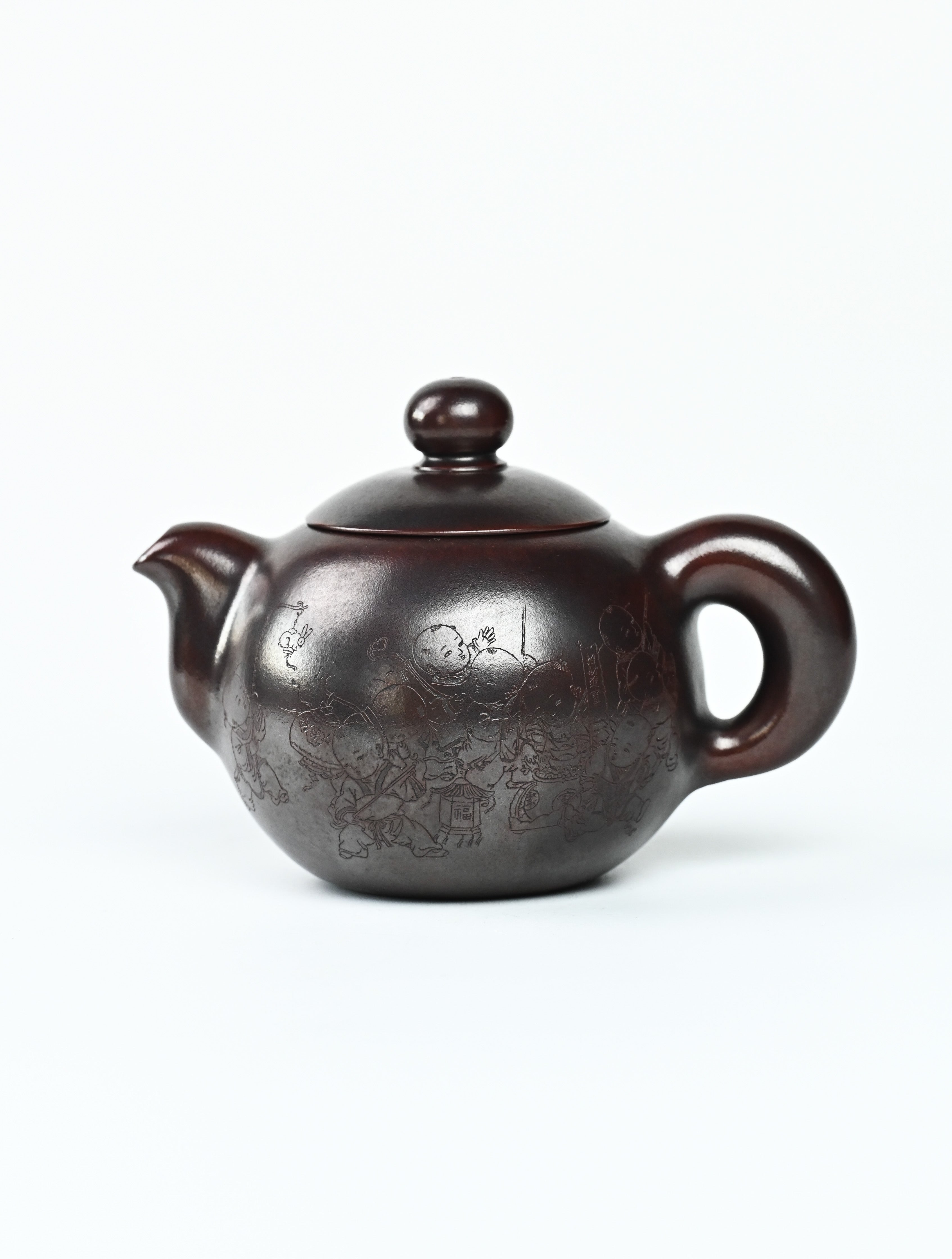 YANYOO handmade Yixing teapot featuring aged Wuni clay and intricate engravings, product left side.