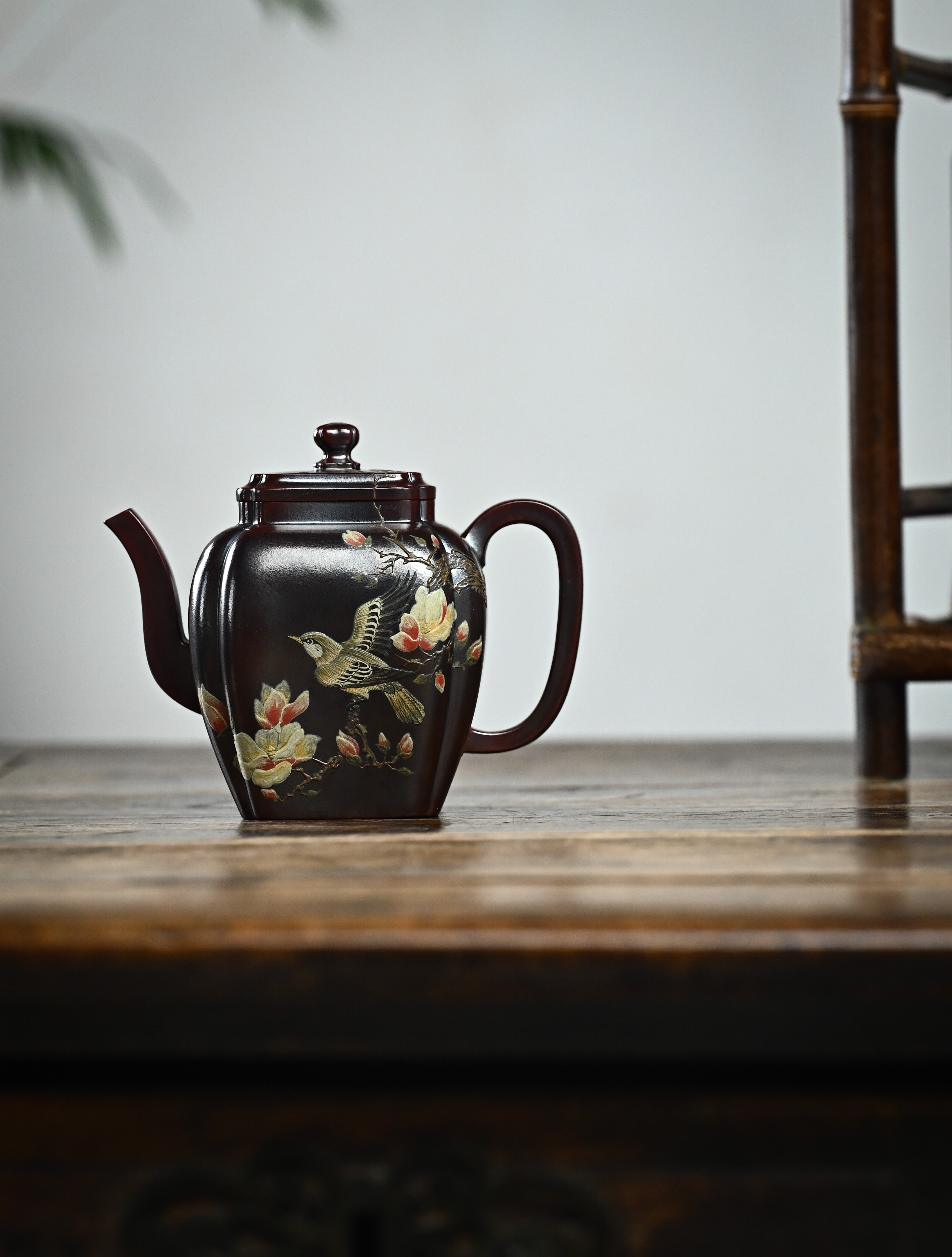 YANYOO handmade Yixing teapot featuring aged Wuni clay, bird-and-flower painting and a unique square shape, Ru Fang, lifestyle wide-angle left side.