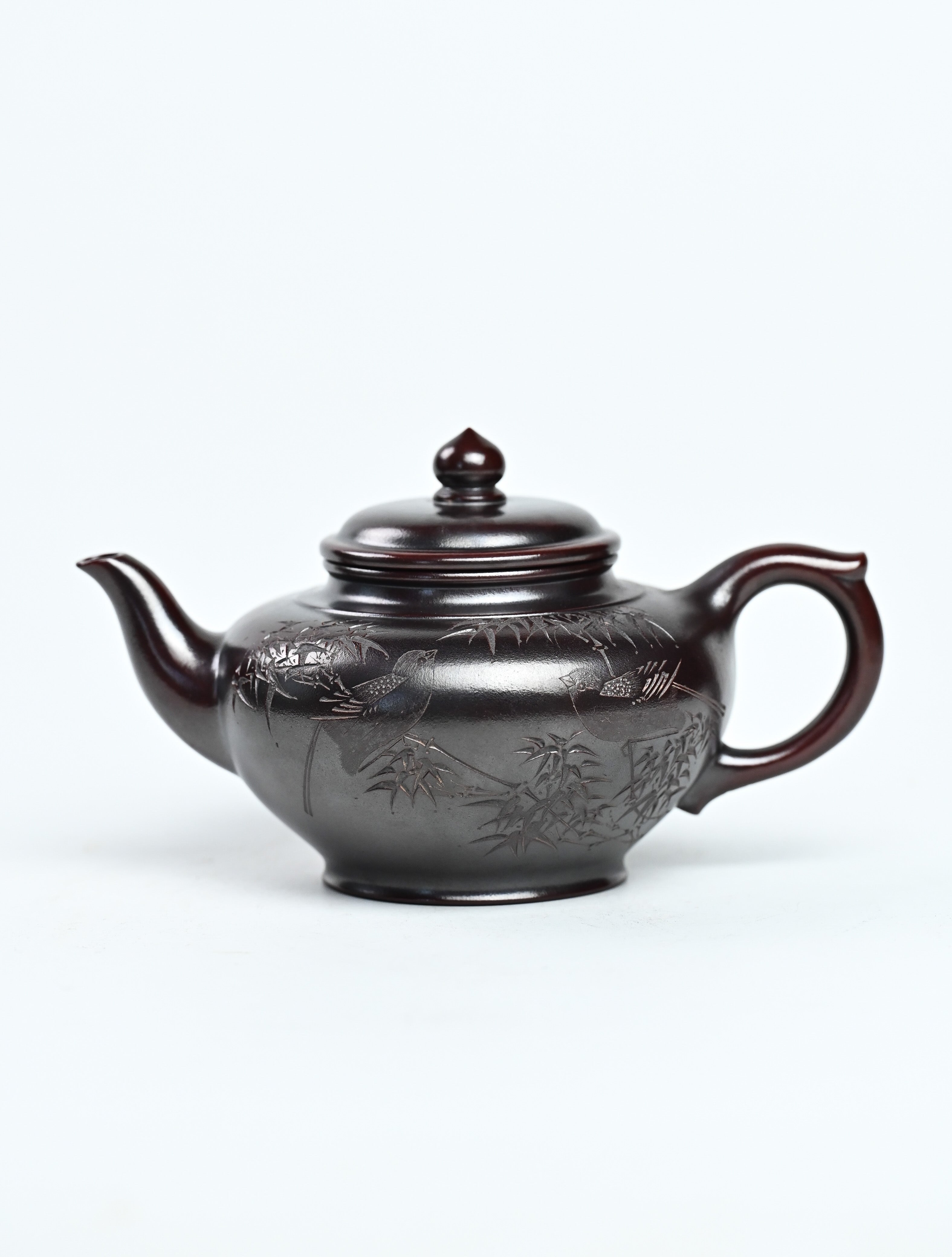 YANYOO handmade Yixing teapot featuring aged Wuni clay and bird engravings, product left side.