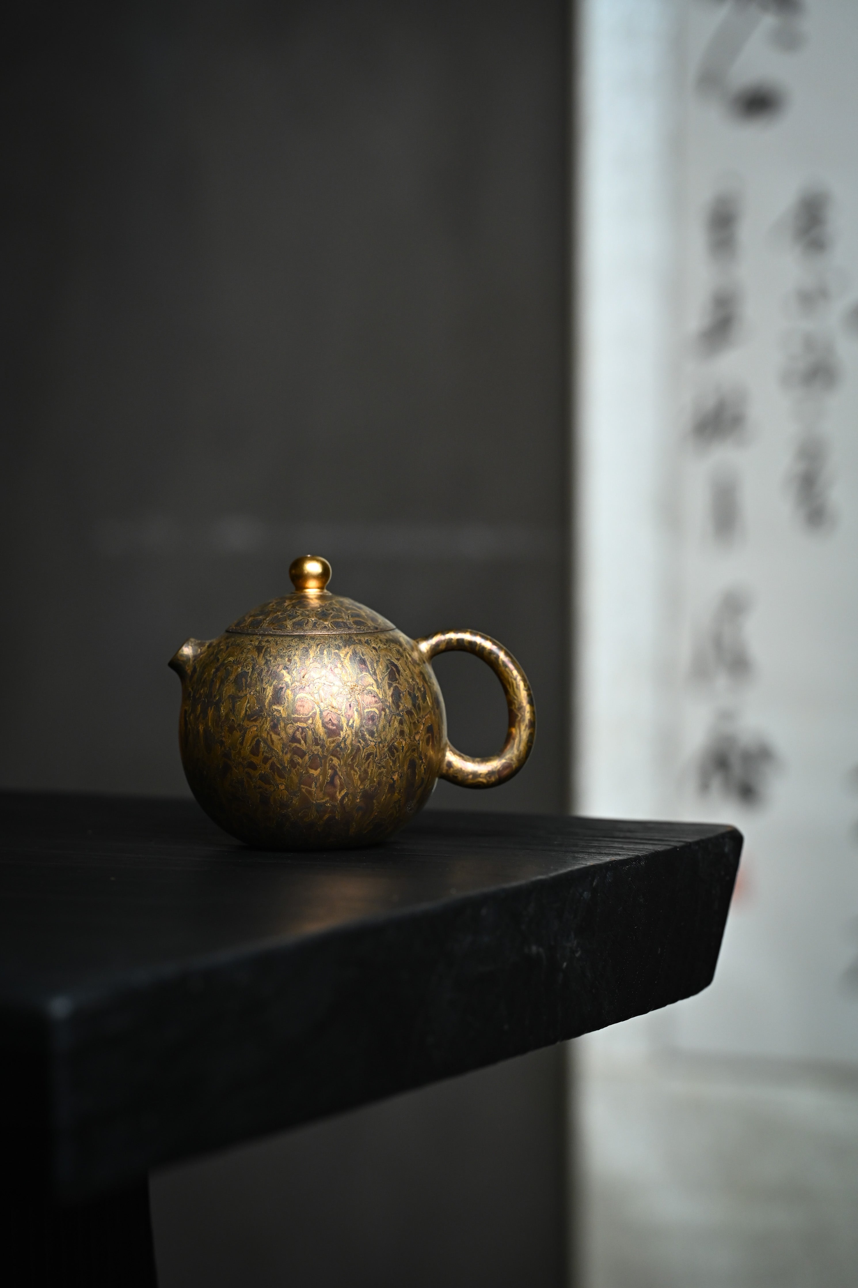 Handmade YANYOO Yixing teapot featuring Feather-Plume firing technique, Long Dan, lifestyle wide-angle left side.