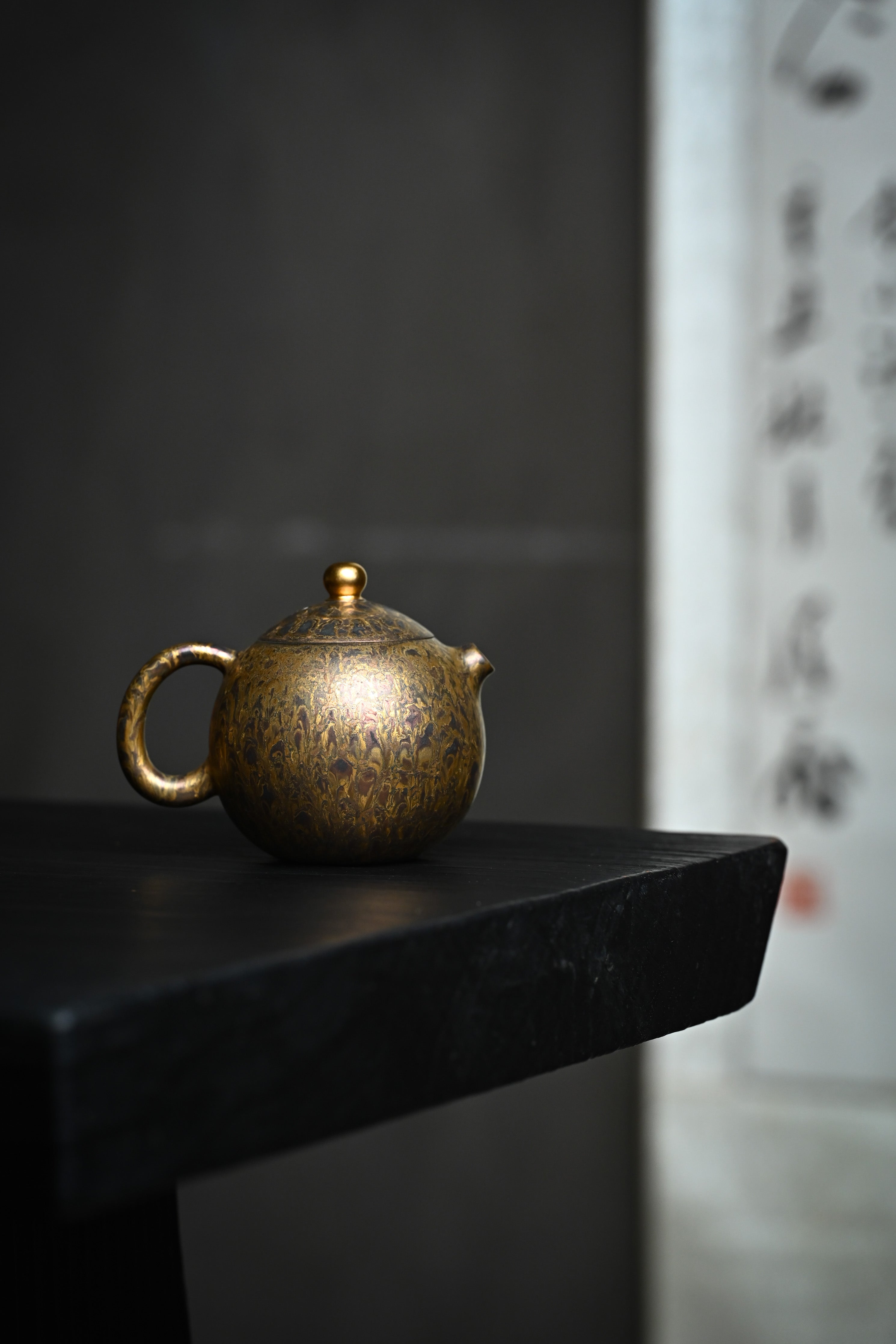 Handmade YANYOO Yixing teapot featuring Feather-Plume firing technique, Long Dan, lifestyle wide-angle right side.