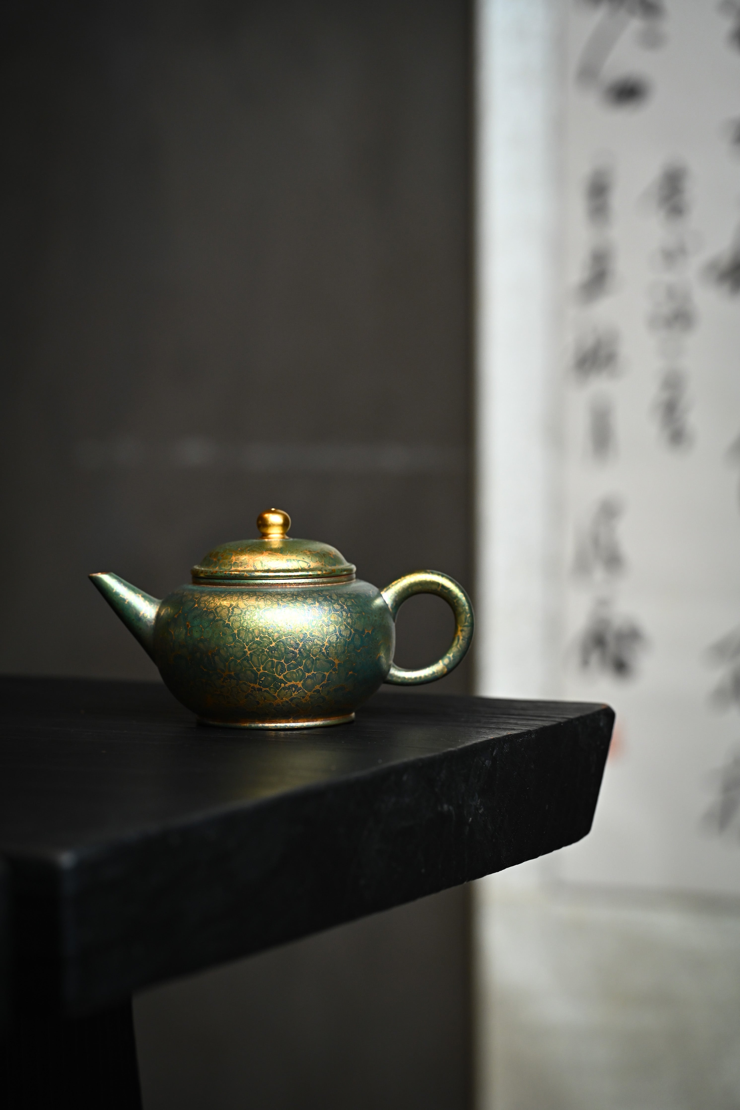 Handmade YANYOO Yixing teapot featuring Feather-Plume firing technique, Shui Ping Matcha, lifestyle wide-angle left side.