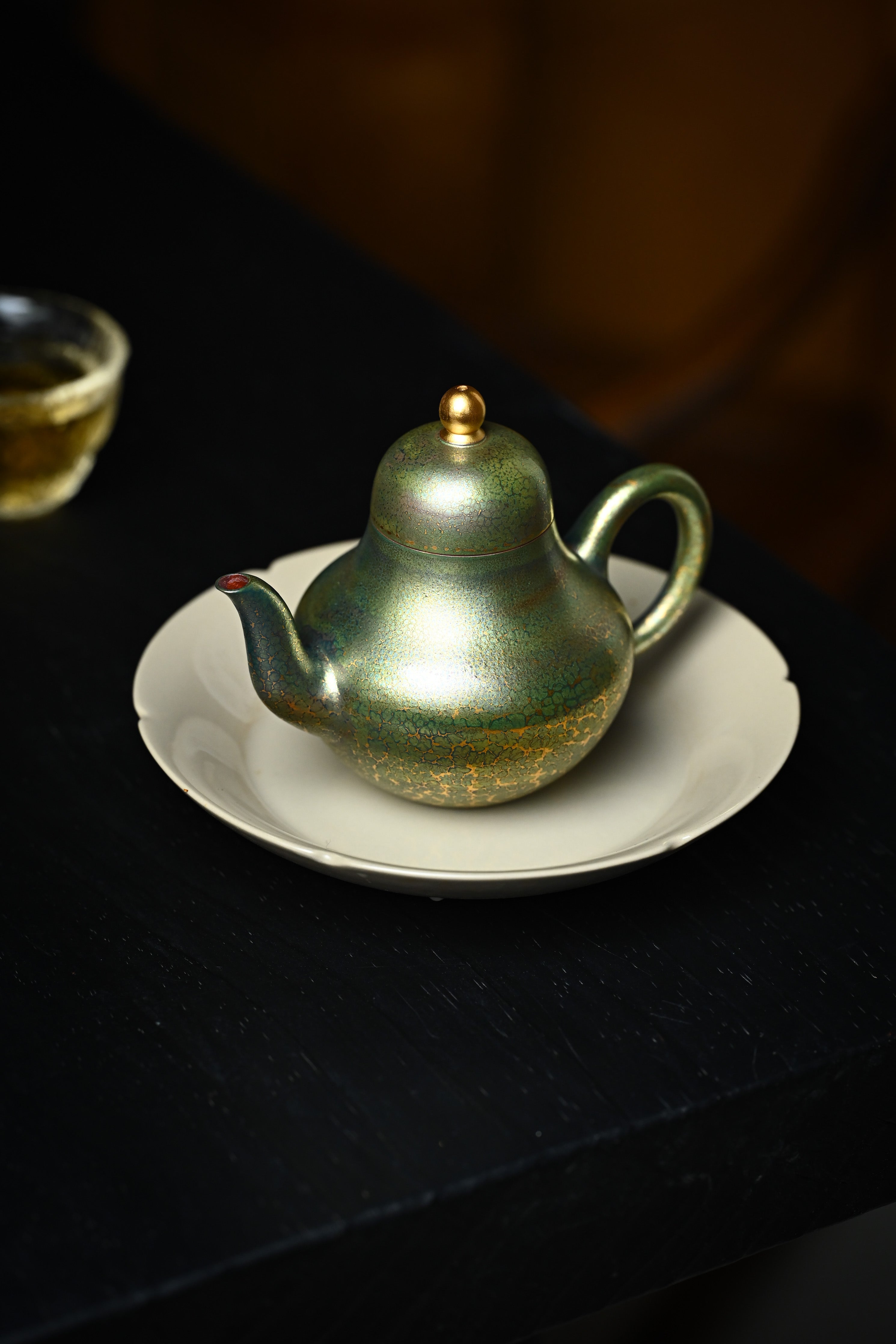 Handmade YANYOO Yixing teapot featuring Feather-Plume firing technique, Si Ting Matcha, lifestyle left side.