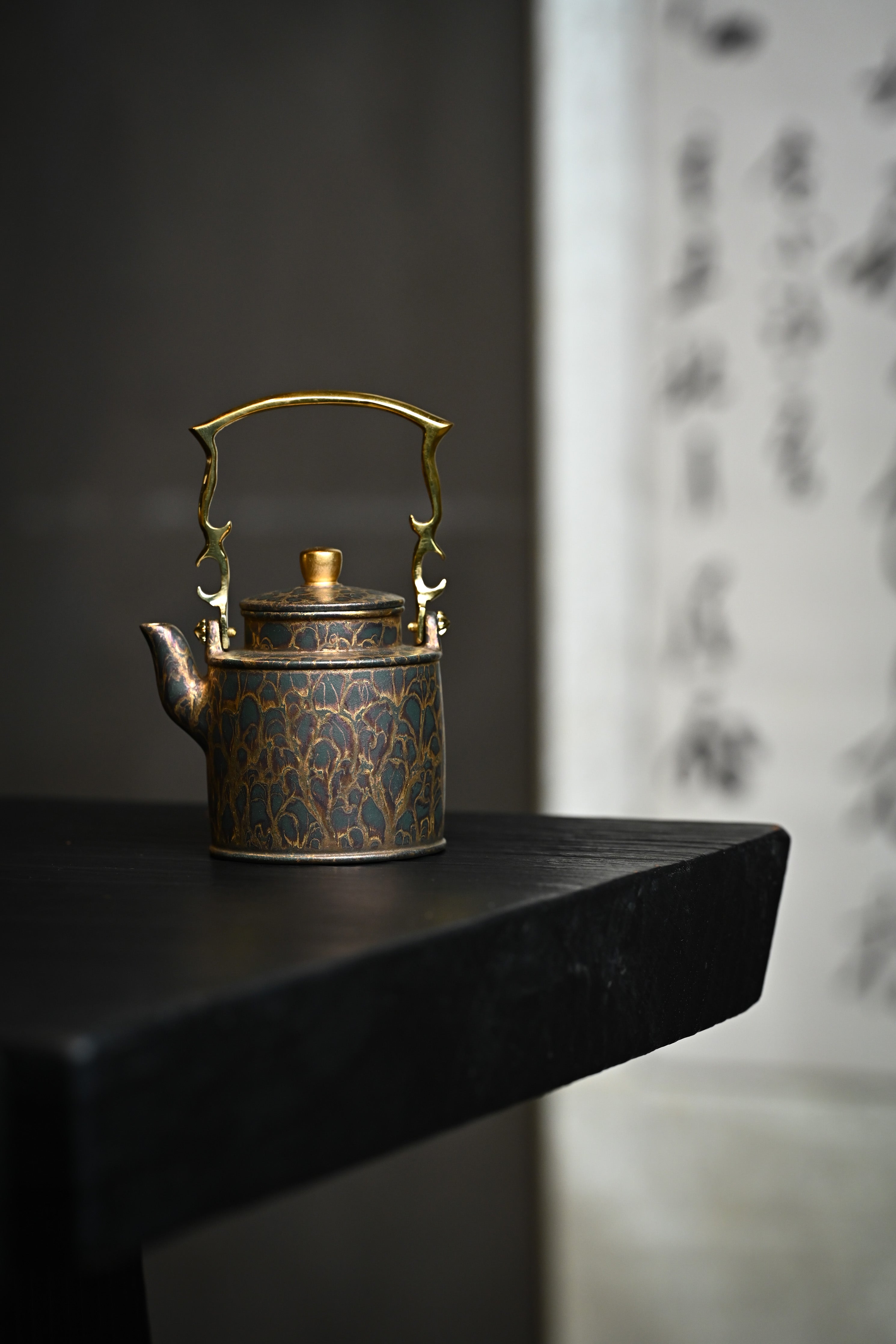 Handmade YANYOO Yixing teapot featuring Feather-Plume firing technique, Yang Tong, lifestyle wide-angle left side.